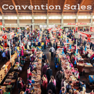 A crowded market with rows of vendors at tables - caption reads 'Convention Sales'